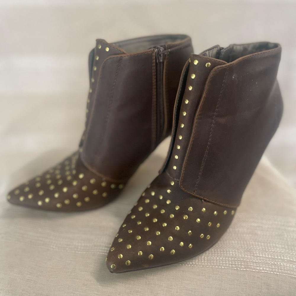 Brown ankle booties with gold studs at the toes